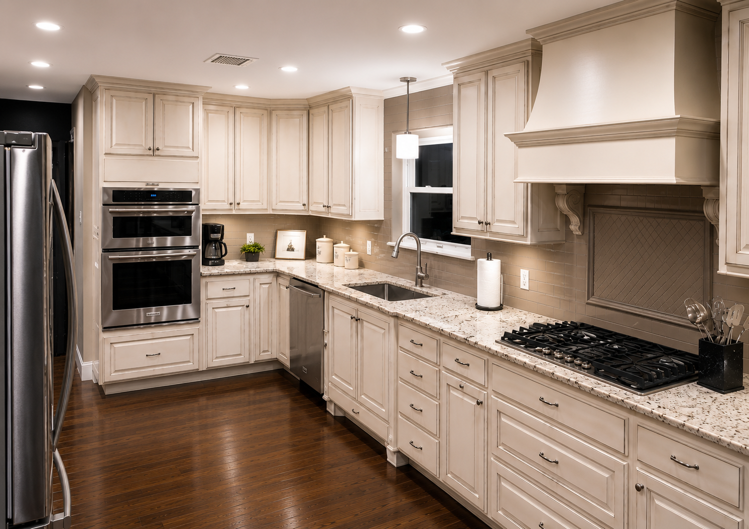 Kitchen Remodel by Masons Quality Construction Company Texas City Custom kitchen remodel featuring white shaker cabinets, granite countertops, stainless steel appliances, and hardwood floors
